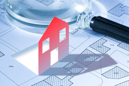 Imaginary cadastral map of territory with buildings, roads and land parcel - concept with a small houseの写真素材