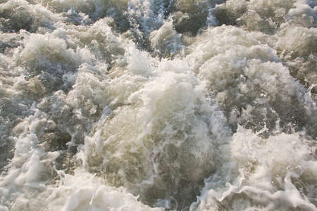 Dirty rushing water background of a river in floodの写真素材