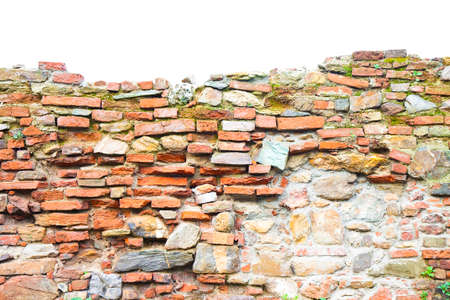 Old stone and brick wall with degraded plaster on white backgroundの写真素材