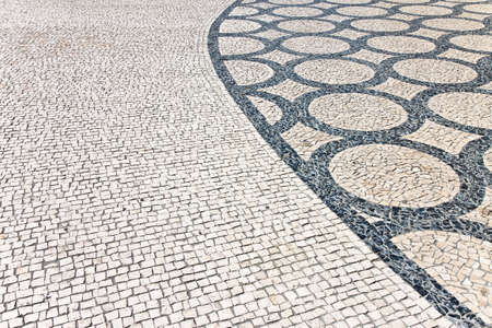 Typical Portuguese floor. Typical Portuguese floor made of small pieces of colored stone in shape of...