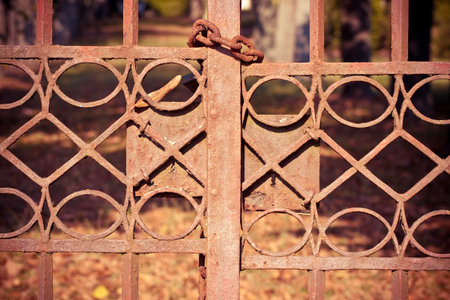 Rusty metal gate closed with chain and padlockの写真素材
