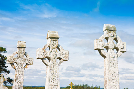 Celtic carved stone cross against a sky background.の写真素材