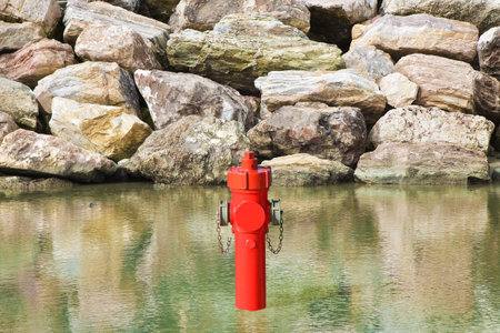 An improbable hydrant at the seaside. Plenty of water concept imageの写真素材