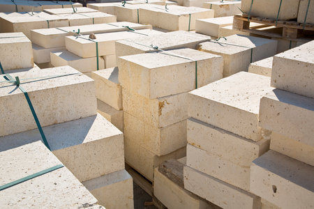 Wooden pallet of new travertine stone slabs ready to be mounted in a new pavement in an urban...