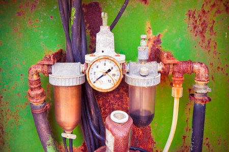 Old rusty disused manometer on colored backgroundの写真素材