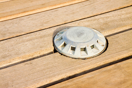 Recessed floor lamp on old wooden floor - image with copy spaceの写真素材