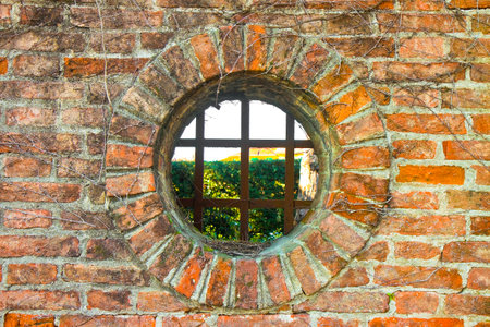 Old round window on brick wallの写真素材