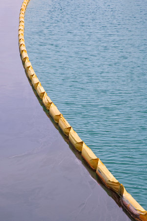 Floating anti-pollution barrier made with modular plastic elements to protect from water pollution - Environmental protection conceptの写真素材