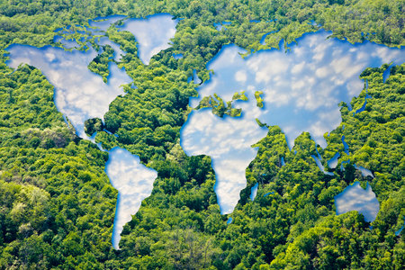 Global map of the World against a woodland with cloudy sky - global village and environmental...