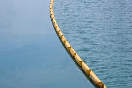 Floating anti-pollution barrier made with modular plastic elements to protect from water pollution - Environmental protection conceptの写真素材