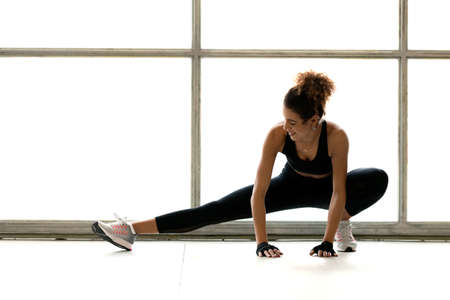 Young sporty woman is doing excercises and stretchingの写真素材