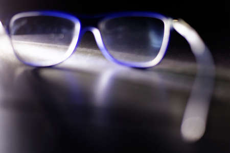 Eye blue glasses on a dark backgroundの写真素材