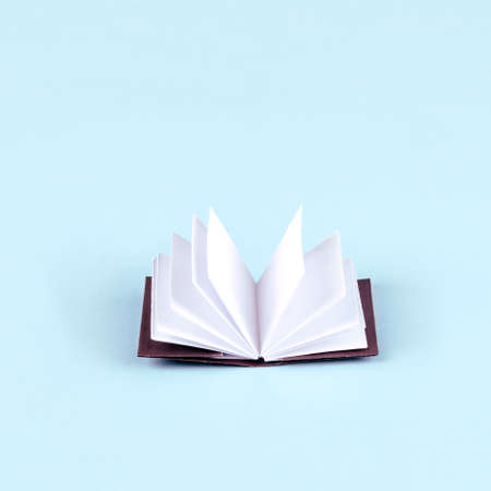 Origami white paper book on blue backgroundの写真素材