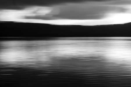 Vivid lights of the lake sunset with long exposure effect. Balck and whiteの写真素材