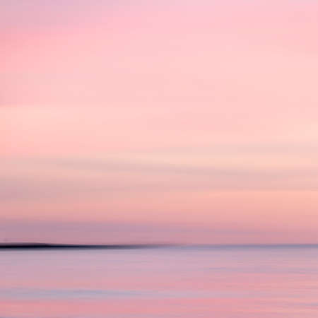 abstract landscape of sea. texture water, sky and sand in blurry motion in tropical sunset colorsの写真素材