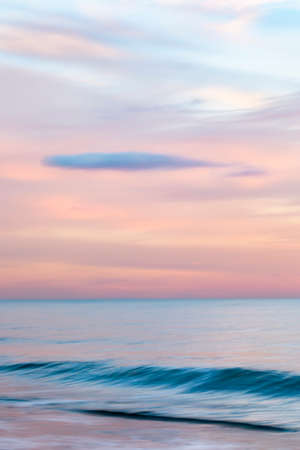 abstract landscape of sea. texture water, sky and sand in blurry motion in tropical sunset colorsの写真素材