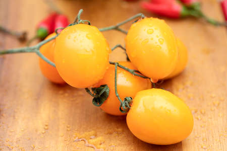 Fresh vegetables on a table. Composition orange tomatoes.の写真素材