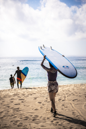 BALI, INDONESIA - OCTOBER 2018: surfers at beachのeditorial素材