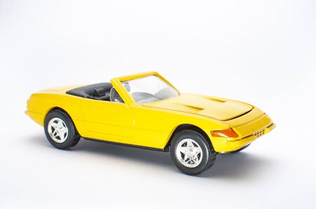 Yellow toy car on white background
