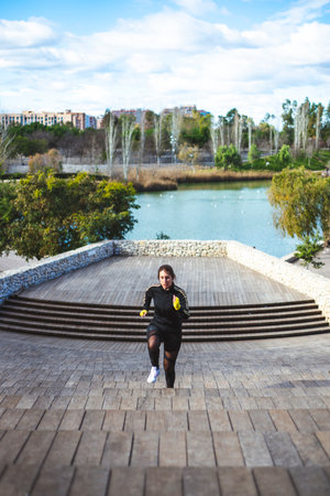 Runner athlete running on stairs. Woman fitness jogging workout concept.の写真素材