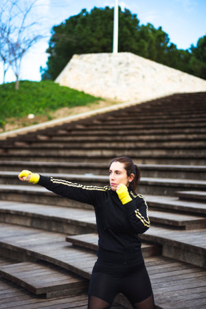 Girl training body combat at park. Self defense conceptの写真素材
