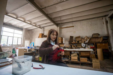 Spanish woman working at a hand fan design workshopの写真素材