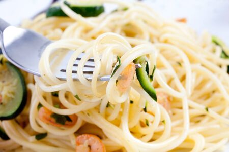 spaghetti with zucchini and shrimpsの写真素材