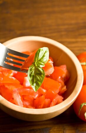 cutted tomatoes with basilの写真素材