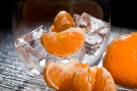 photo of delicious orange mandarins on ice cubesの写真素材