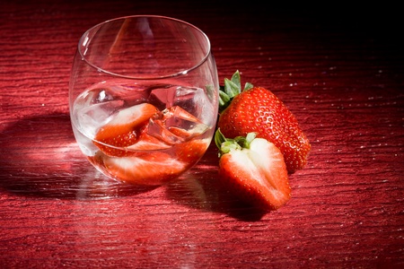 photo of strawberries on ice on red tableの写真素材