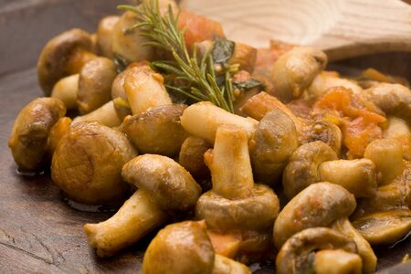cooked mushrooms with fresh tomatoe and rosemaryの写真素材