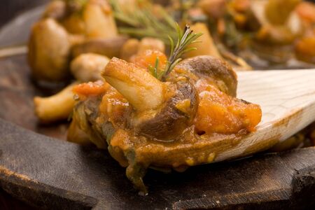 cooked mushrooms with fresh tomatoe and rosemaryの写真素材