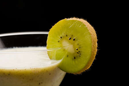 photo of delicious kiwi milkshake in cocktailglass with kiwi slice on itの写真素材