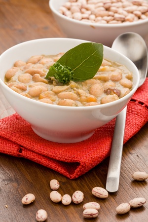photo of delicious beans soup on red cloth standing on wood tableの写真素材