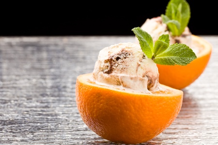 photo of cutted orange with ice cream and mint on itの写真素材