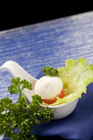 photo of delicious tomatoe and mozzarella appetizer in spoonの写真素材
