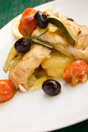 photo of delicious baked cod with olives and tomatoesの写真素材