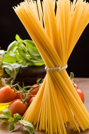 photo of different ingredients for italian pasta with tomatoes and basilの写真素材