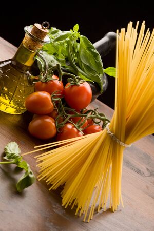photo of different ingredients for italian pasta with tomatoes and basilの写真素材