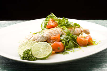 photo of grilled chicken breast with fresh green rocket saladの写真素材