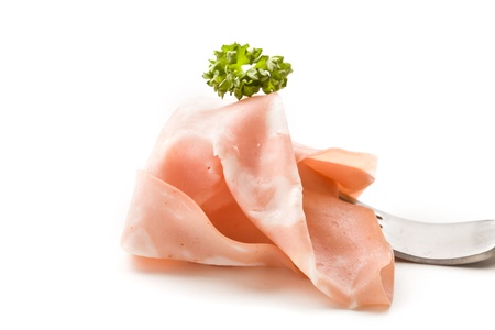photo of fork with thin slice of mortadella ham and parsleyの写真素材