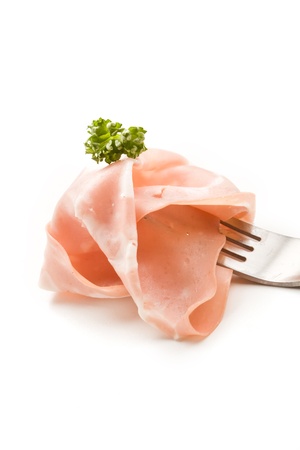 photo of fork with thin slice of mortadella ham and parsleyの写真素材