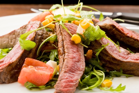 delicious slices of meat with rocket salad and toamtoes の写真素材
