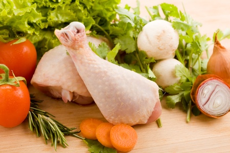 photo of wooden chopping board with chicken and vegetables の写真素材