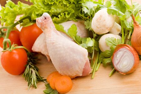 photo of wooden chopping board with chicken and vegetables の写真素材