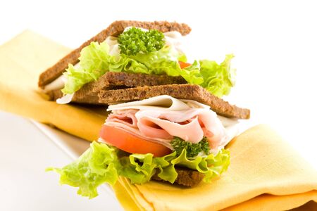 photo of delicious big cheese and ham sandwich with lettuce on white isolated backgroundの写真素材