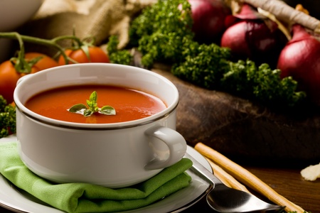 photo ofo delicious tomato soup with vegetables on wooden tableの写真素材