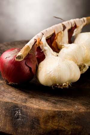 photo of onion and garlic on wooden table の写真素材