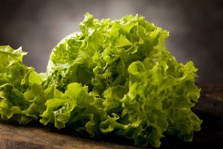 photo of fresh green lettuce on wooden tableの写真素材