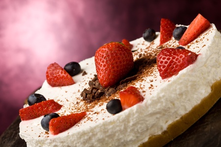 photo of delicious cake with strawberries on wooden tableの写真素材